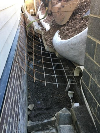 The unsupported wall gave way under the weight of aggregate-filled grab bags