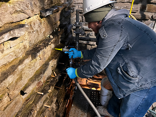 The liquid grout is being injected through the system of ports.