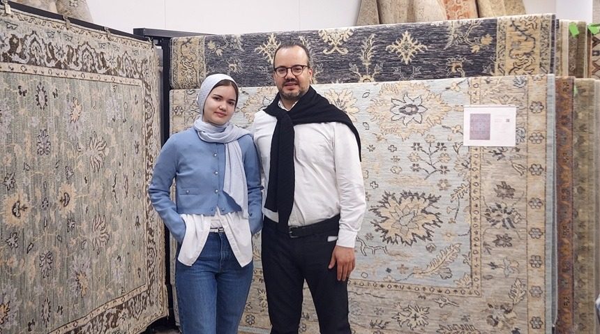 Cappadocia Rugs family owners, daughter Hafsa Koker, left, and father Ahmet Koker, in front of one of the new rugs in their High Point showroom.
