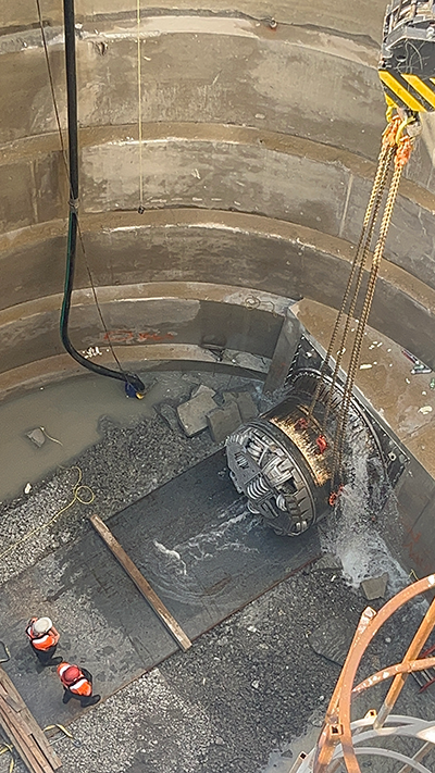 The first of the two 1.5-metre tunnels breaks through the canal wall in early July.